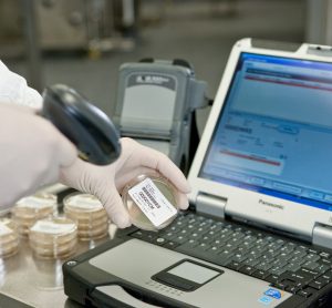 Scientist using scanner to read barcode - MODA-EM™ Paperless Solution [© Lonza, Basel]