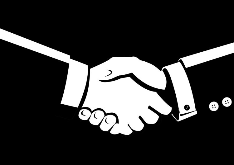 Black and white illustration of shaking hands - idea of mergers and acquistions