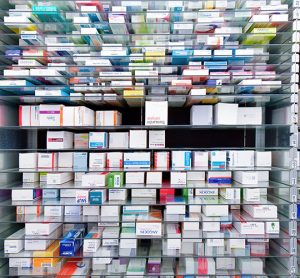 shelves of boxes containing pharmaceuticals - idea of pharmaceutical packaging