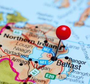 map of Northern Ireland with a red pin sticking out of Belfast - the capital city