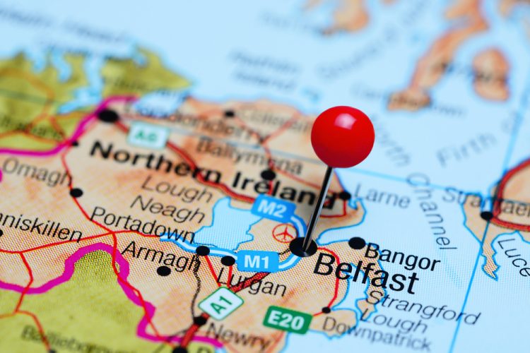 map of Northern Ireland with a red pin sticking out of Belfast - the capital city