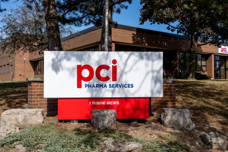 PCI Pharma Services logo on sign outside Canadian facility [Credit: JHVEPhoto/Shutterstock.com].