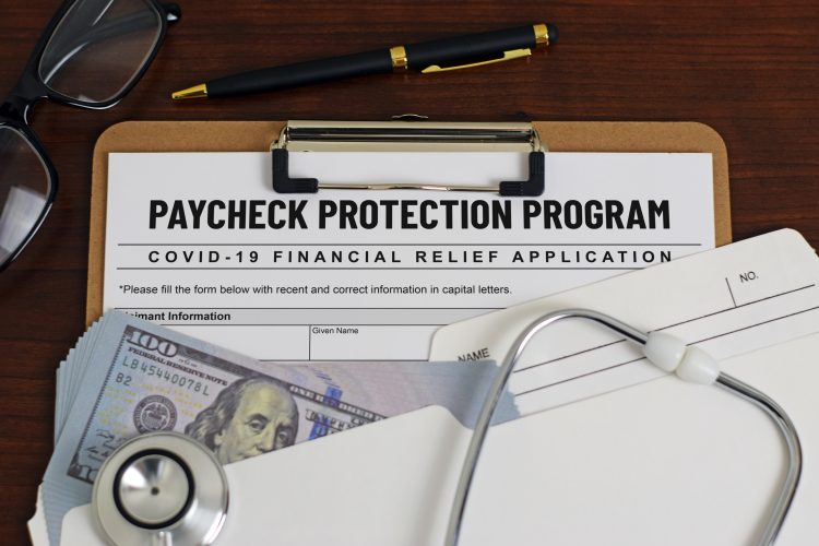 mock application form labelled 'PAYMENT PROTECTION PROGRAM' surrounded by stethoscope and US Dollars