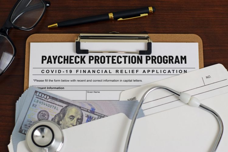 mock application form labelled 'PAYMENT PROTECTION PROGRAM' surrounded by stethoscope and US Dollars