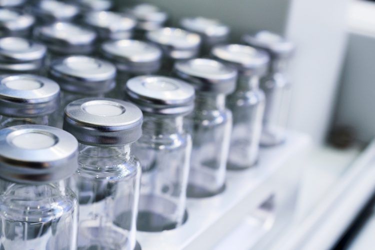 Glass vials for drug containment lined up in rows