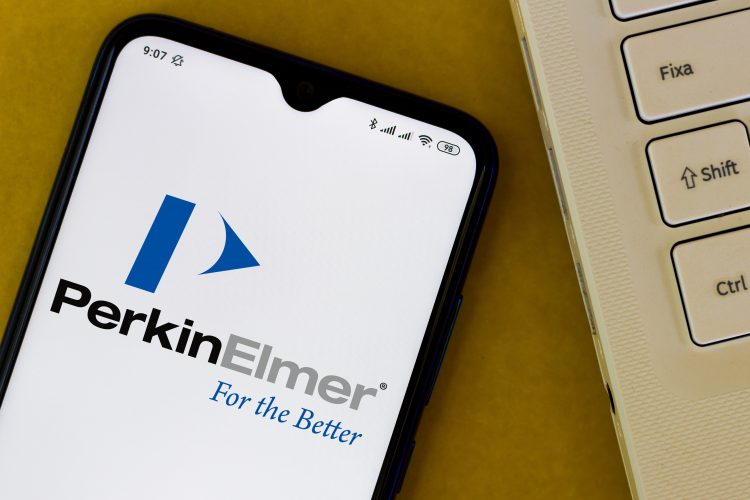 Phone screen displaying PerkinElmer logo next to a laptop keyboard [Credit: rafapress / Shutterstock.com].