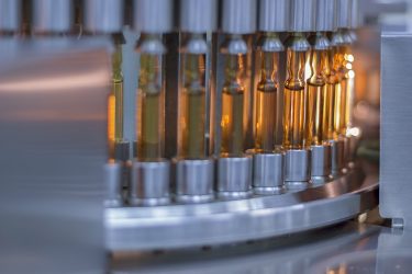 vials of medication loaded on an inspection machine