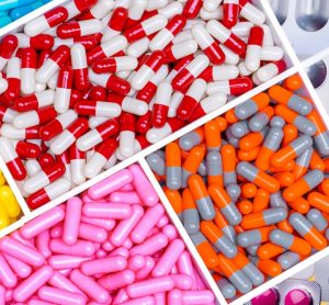 Different colours and types of pharmaceuticals (pills, tablets and capsules)