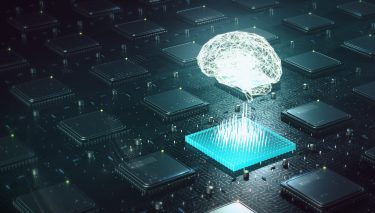 glowing outline of brain hovering over a lit up blue computer chip - idea of artificial intelligence/machine learning