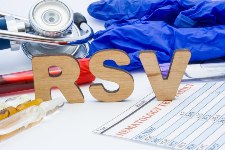 Letters spelling RSV surrounded by various medical equipment and medications - idea of treatment/vaccine development for RSV