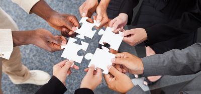 Close-up Photo Of Business people Holding Jigsaw Puzzle Pieces