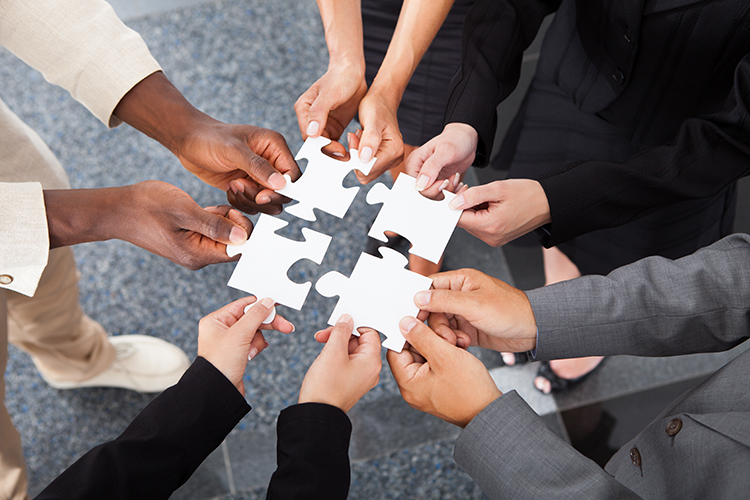 Close-up Photo Of Business people Holding Jigsaw Puzzle Pieces