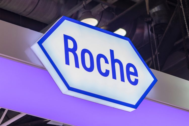 Roche logo sign lit up [Credit: testing/Shutterstock.com].