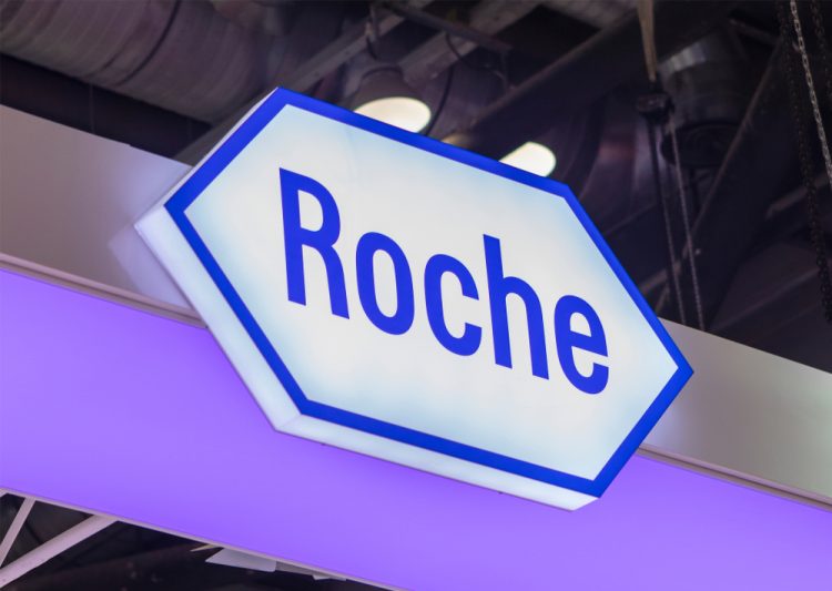 Roche logo sign lit up [Credit: testing/Shutterstock.com].