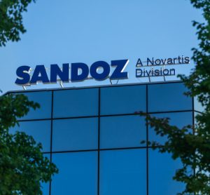 Sandoz company logo on office building in Warsaw city centre [Credit: Konektus Photo/Shutterstock.com].