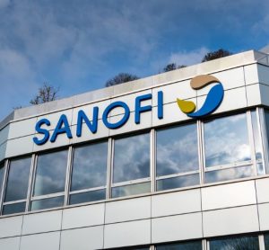 Sanofi logo on top of building [Credit: HJBC/Shutterstock.com].