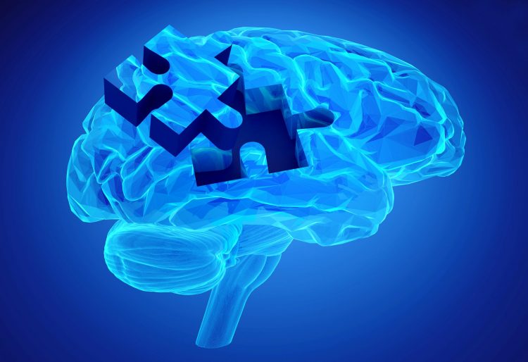 glowing blue brain with a puzzle peice removed and laying to the side - idea of cognitive impairment