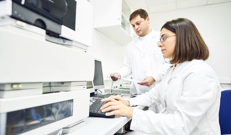 Scientists in lab performing two dimensional liquid chromatography