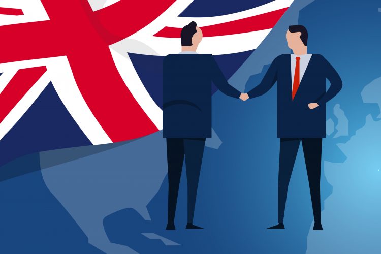 artoon of business people shaking hands in frnt of Union Jack flag