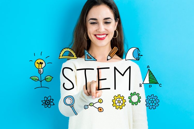 Word 'STEM' surrounded by symbols representing maths, computing and science overlaid on a smiling woman in a white work shirt