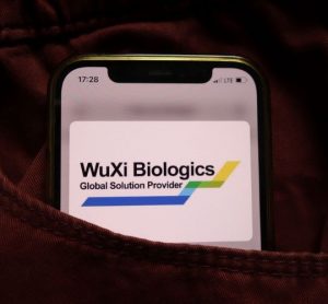 WuXi Biologics logo on a lit up phone screen [Credit: Piotr Swat/Shutterstock.com].