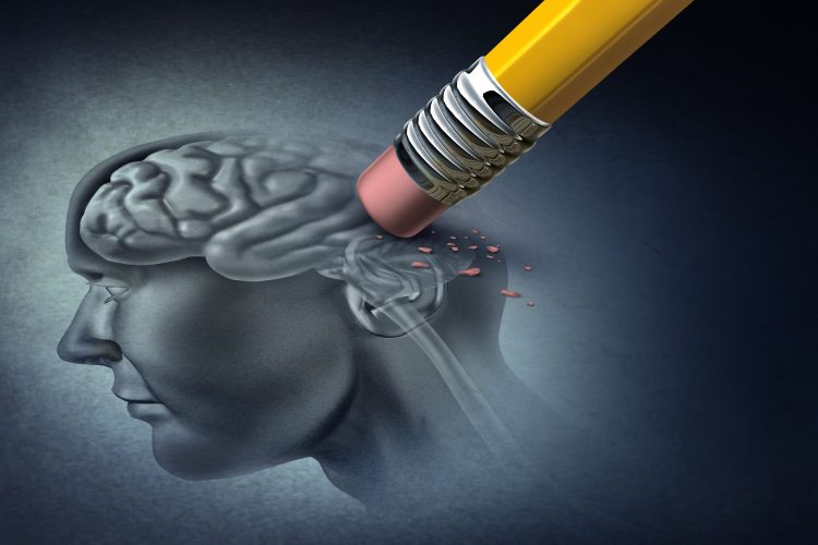 Alzheimer's disease concept - rubber on the end of a pencil erasing the back of a drawing of the human skull and brain - idea of neurodegeneration