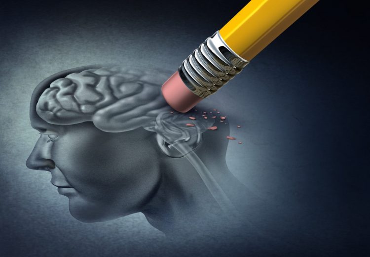 Alzheimer's disease concept - rubber on the end of a pencil erasing the back of a drawing of the human skull and brain - idea of neurodegeneration
