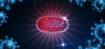 Futuristic antiviral medication against coronavirus sars-cov2 viral disease covid-19 with glowing red capsule pill and virus cells on dark blue background.