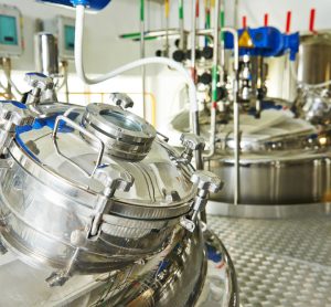 stainless steel bioreactors in a factory - idea of biopharmaceutical production/drug development