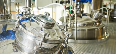 stainless steel bioreactors in a factory - idea of biopharmaceutical production/drug development
