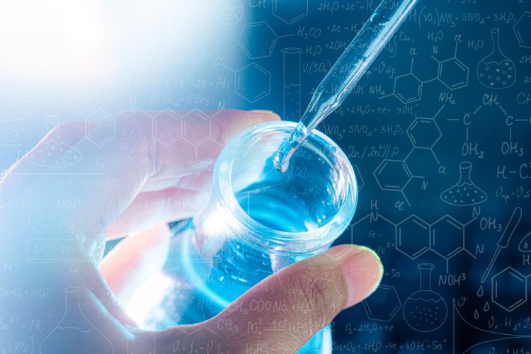 hand holding liquid vial and pipette - concept of biosimilar medicine