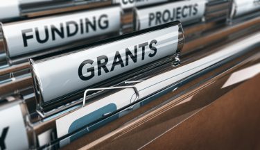 folders labelled funding, grants and projects in a filing cabinet 