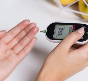 diabetic person testing their blood glucose level