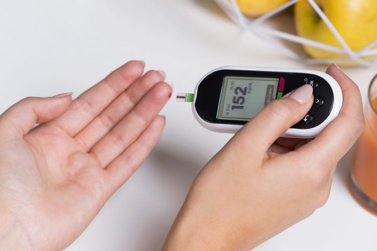 diabetic person testing their blood glucose level