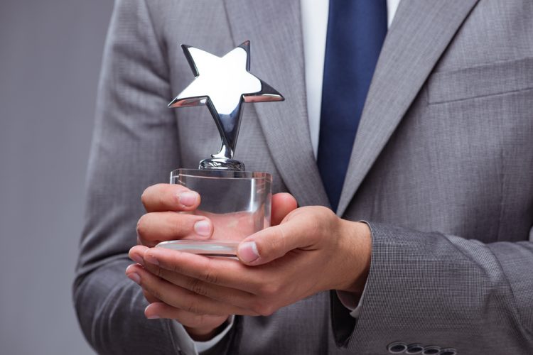 Businessman holding star award