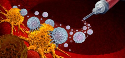 3D rendering of a syringe of red liquid generating white immune cells that are attacking a yellow cancer cell - idea of a cancer vaccine