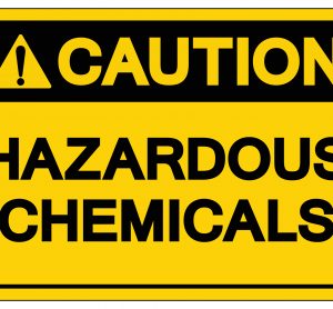 yellow warning label reading 'caution hazardous chemicals' in black
