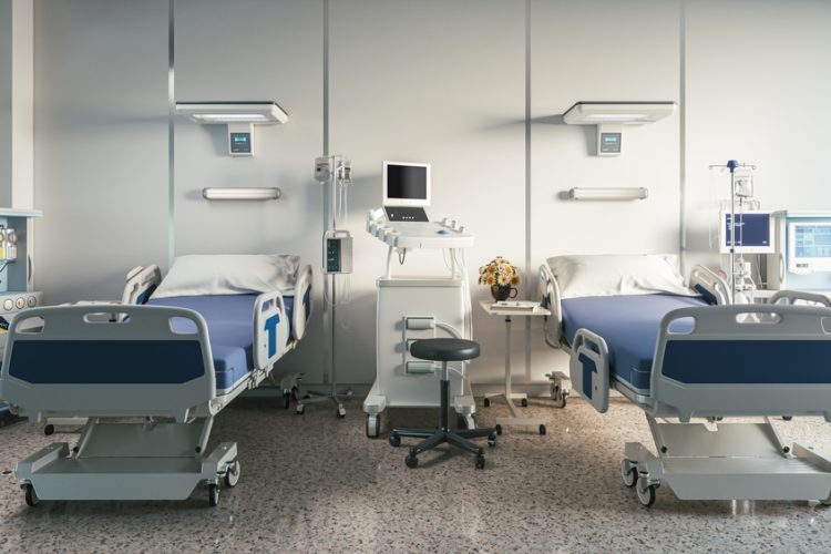 two empty hospital beds on a ward - idea of clinical research/trials