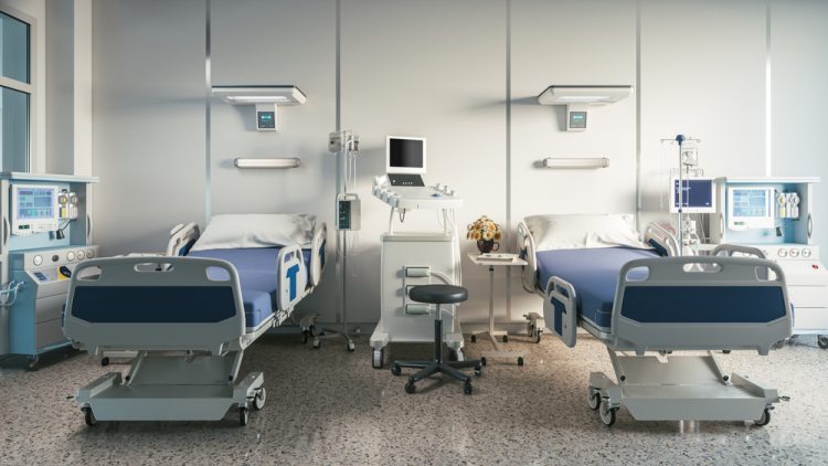 two empty hospital beds on a ward - idea of clinical research/trials