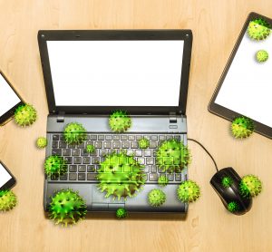 green coronavirus particles on cartoon laptop, mouse and other devices