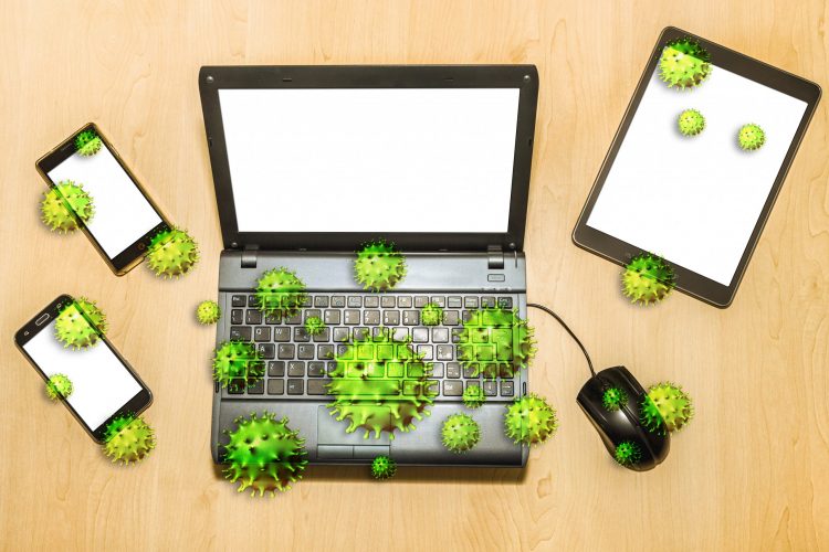 green coronavirus particles on cartoon laptop, mouse and other devices