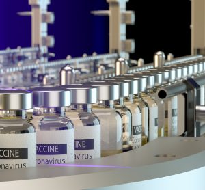 vials labelled 'CORONAVIRUS VACCINE' on a production line