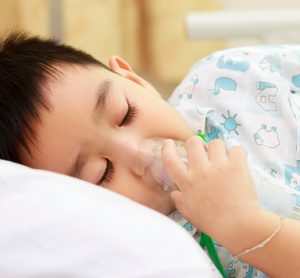 hospitalised child with oxygen mask