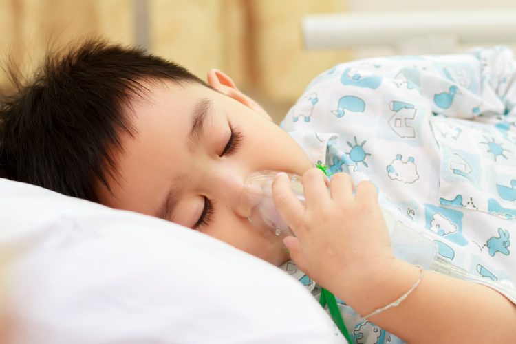 hospitalised child with oxygen mask