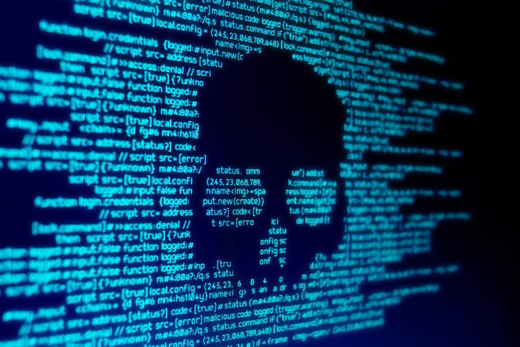 computer code in glowing blue with a black skull shape in the middle - idea of a cyber attack