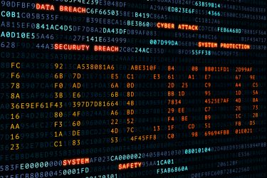 cyber attack concept - word 'HACKED' spelled out in code on a computer screen