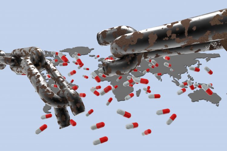 chain with a broken link in front of a world map with medicine capsules on it