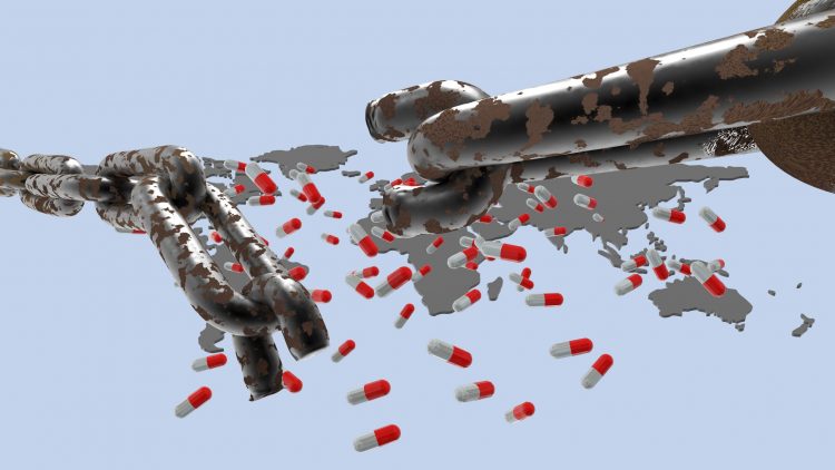 chain with a broken link in front of a world map with medicine capsules on it