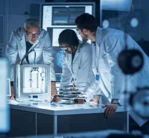 Diverse group of scientist collaborating on research/a project in a lab