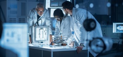 Diverse group of scientist collaborating on research/a project in a lab